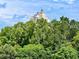 Luxury building view from behind trees at 7612 Cabana Ct # 303, Reunion, FL 34747