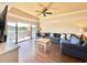 Spacious living room with sectional sofa, hardwood floors, and access to a balcony at 7612 Cabana Ct # 303, Reunion, FL 34747