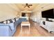 Open living room with hardwood floors, sectional sofa, and a view of the dining area at 7612 Cabana Ct # 303, Reunion, FL 34747