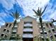 Building exterior with palm trees and balconies at 7612 Cabana Ct # 303, Reunion, FL 34747