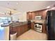 Well-equipped kitchen with dark wood cabinets, granite countertops, and stainless steel appliances at 7612 Cabana Ct # 303, Reunion, FL 34747