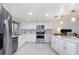 Modern white kitchen with stainless steel appliances and an island at 1054 Lotus Cove Ct # 642, Altamonte Springs, FL 32714