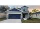 Two-story house with gray siding and a dark navy garage door at 174 14Th Avenue, Longwood, FL 32750