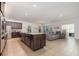 Kitchen with large island, granite countertops, dark brown cabinets and stainless steel appliances at 1989 Marsh Hen Vlg, Deland, FL 32720
