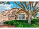 Two-story home with attractive landscaping and large tree at 23907 Sardinia Dr, Sorrento, FL 32776