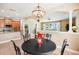 Elegant dining room with a chandelier and seating for four at 23907 Sardinia Dr, Sorrento, FL 32776