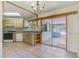 A dining room with tiled floors and sliding glass doors to a screened porch at 2763 E Waco Dr, Deltona, FL 32738