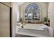 Relaxing bathroom featuring a built in soaking tub and large window at 2822 Tupelo Ct, Longwood, FL 32779