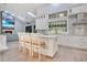 White kitchen island with seating, modern cabinets, and a view into the living room at 2822 Tupelo Ct, Longwood, FL 32779