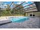 Relaxing pool and spa area with covered patio and lush landscaping at 2822 Tupelo Ct, Longwood, FL 32779