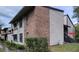 Condo building exterior with brick and siding, showcasing stairs and AC unit at 4641 Cason Cove Dr # 2124, Orlando, FL 32811