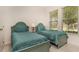 Bedroom with two twin beds, teal bedding, and shared bathroom at 5160 Oakbourne Ave, Davenport, FL 33837