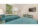 Bedroom with two twin beds, teal bedding, and shared bathroom at 5160 Oakbourne Ave, Davenport, FL 33837