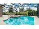 Screened pool and spa with lounge chairs at 5160 Oakbourne Ave, Davenport, FL 33837