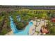 Aerial view of a resort-style lazy river pool with surrounding landscaping at 5160 Oakbourne Ave, Davenport, FL 33837