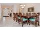 Formal dining room with large wood table and teal chairs at 5160 Oakbourne Ave, Davenport, FL 33837