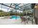 Screened pool and spa with patio dining set at 5160 Oakbourne Ave, Davenport, FL 33837