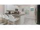 Modern kitchen with white cabinets, granite countertops, and stainless steel appliances at 5160 Oakbourne Ave, Davenport, FL 33837
