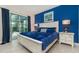 Main bedroom with a king bed, blue color scheme and access to the pool area at 5160 Oakbourne Ave, Davenport, FL 33837