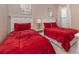 Bedroom with two twin beds, red bedding, and shared bathroom at 5160 Oakbourne Ave, Davenport, FL 33837