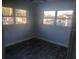 Bright bedroom with gray walls, dark gray flooring, and multiple windows at 5900 Judy Dee Dr, Orlando, FL 32808