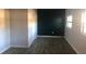 Simple bedroom with dark gray flooring and a dark teal accent wall at 5900 Judy Dee Dr, Orlando, FL 32808