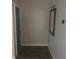 Clean entryway with wood-look flooring, a mirror, and a door at 5900 Judy Dee Dr, Orlando, FL 32808