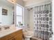 Clean bathroom with shower/tub combo and patterned shower curtain at 7471 Crooked Lake Cir, Orlando, FL 32818