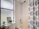 Bathroom with shower and tub, framed window, and decorative touches at 7471 Crooked Lake Cir, Orlando, FL 32818