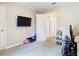Bedroom with TV, dresser, and additional space for sleeping at 7471 Crooked Lake Cir, Orlando, FL 32818