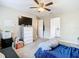 Bedroom with lounger, dresser, and access to the bathroom at 7471 Crooked Lake Cir, Orlando, FL 32818