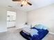 Bedroom with a bed, side table, and view of the bathroom at 7471 Crooked Lake Cir, Orlando, FL 32818