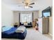Bedroom with a bed, lounger, dresser, and large window at 7471 Crooked Lake Cir, Orlando, FL 32818