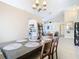 Dining room with a modern table, seating for six, and a view of living room at 7471 Crooked Lake Cir, Orlando, FL 32818