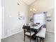 Bright dining area with a large window and modern chandelier at 7471 Crooked Lake Cir, Orlando, FL 32818