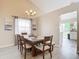 Dining area with a view of the kitchen, and a window with curtains at 7471 Crooked Lake Cir, Orlando, FL 32818
