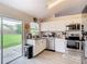 Updated kitchen with white cabinets, granite counters, and sliding door to patio at 7471 Crooked Lake Cir, Orlando, FL 32818