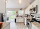 Bright kitchen with granite countertops, stainless steel appliances, and backyard access at 7471 Crooked Lake Cir, Orlando, FL 32818