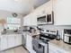 Modern kitchen featuring granite countertops and stainless steel appliances at 7471 Crooked Lake Cir, Orlando, FL 32818