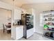 Kitchen with black refrigerator, pantry, and granite countertops at 7471 Crooked Lake Cir, Orlando, FL 32818