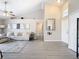 Living room with vaulted ceiling, gray floors, and a large mirror at 7471 Crooked Lake Cir, Orlando, FL 32818