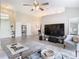 Living room with sectional sofa, large TV, and access to backyard at 7471 Crooked Lake Cir, Orlando, FL 32818