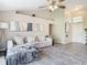 Spacious living room with vaulted ceiling, L-shaped sofa, and a large area rug at 7471 Crooked Lake Cir, Orlando, FL 32818