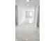 Bright hallway with marble-look flooring and recessed lighting at 9122 Trevarthon Rd, Orlando, FL 32817