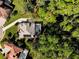 An aerial view of a home with solar panels on the roof and a screened pool at 943 Elm Harbor Ct, Lake Mary, FL 32746