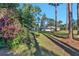 Side view of house with purple flowers and tall trees at 10121 Lone Tree Ln, Orlando, FL 32836