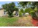 Landscaped backyard with pool and fire pit area at 12512 Tillingham Sw Ct, Orlando, FL 32837