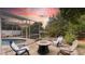 Serene backyard with fire pit and seating area at sunset at 12512 Tillingham Sw Ct, Orlando, FL 32837