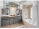 Elegant bathroom with double vanity, soaking tub, and large shower at 12512 Tillingham Sw Ct, Orlando, FL 32837