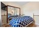 Cozy bedroom with a blue patterned bedspread and mirrored closet at 12512 Tillingham Sw Ct, Orlando, FL 32837